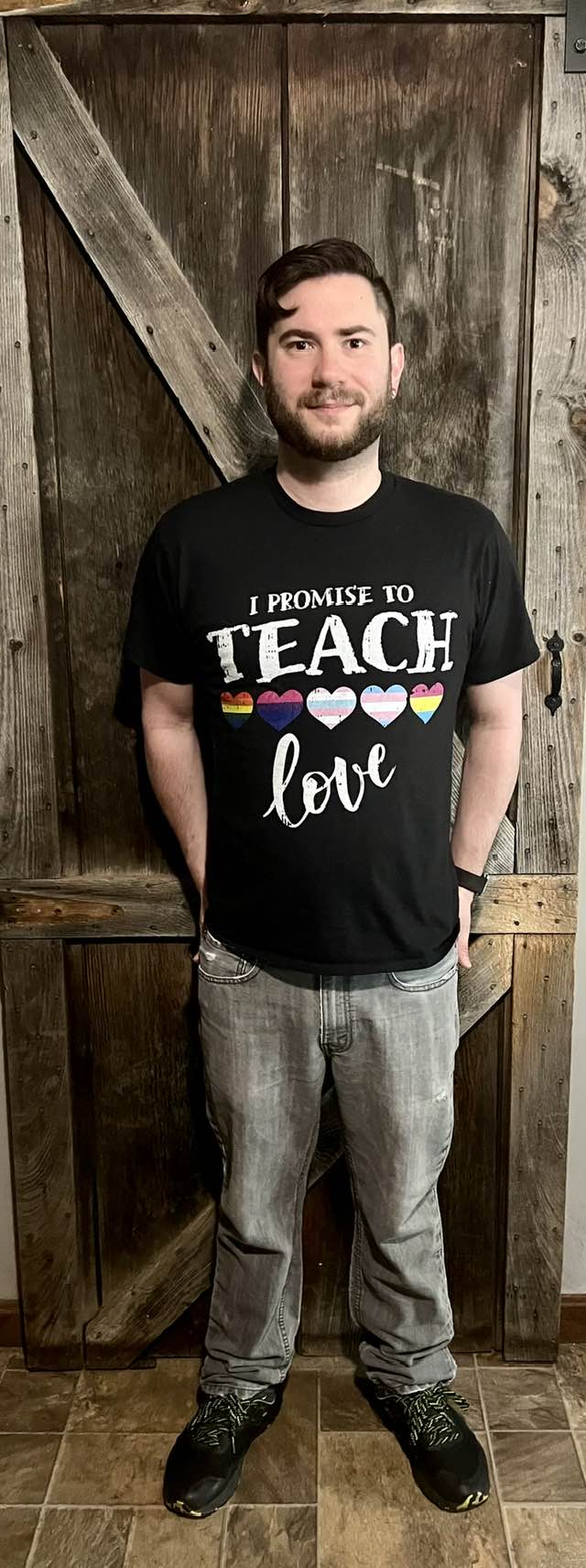 Ben wearing a shirt that says I promise to teach love